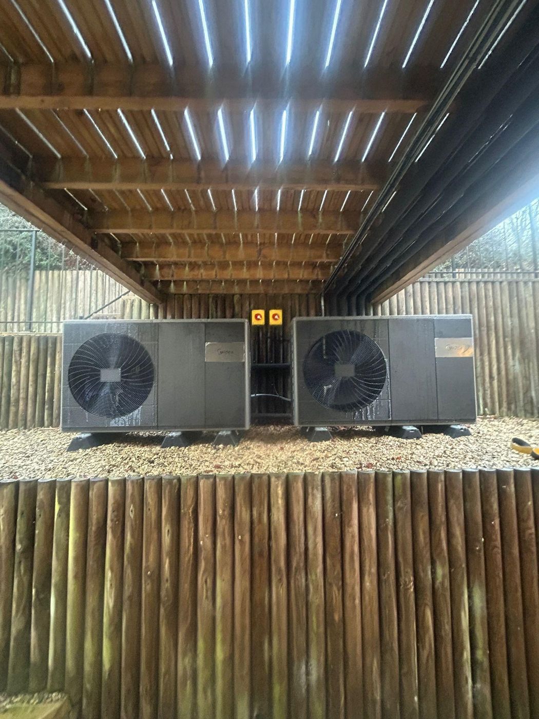 Several air source heat pumps installed side by side in a cascade system.